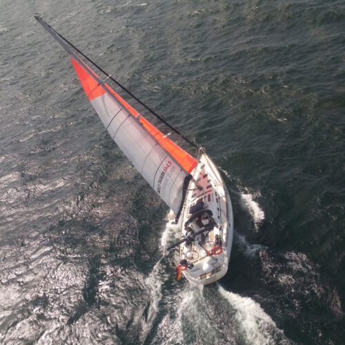 orange tip at the main and bright orange jib